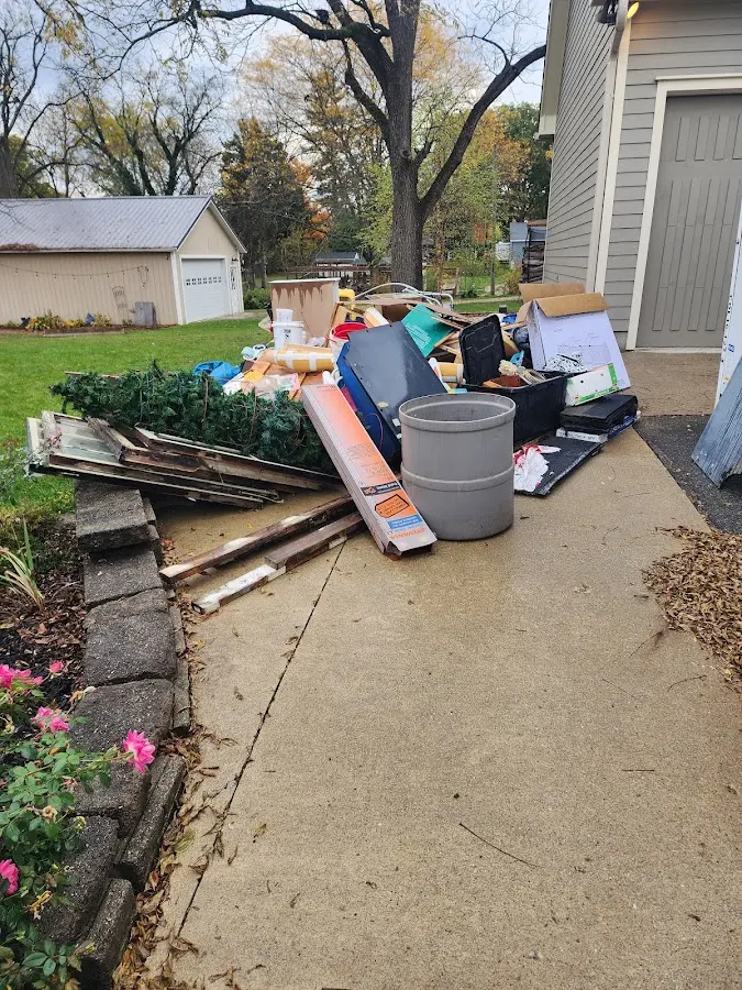 Dumpster being loaded with debris for Roofing Dumpster Rental in Johnston City